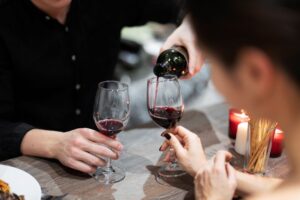 young-couple-celebrating-valentine-s-day-while-having-lunch-wine-together